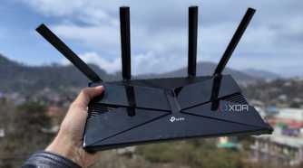A person holding a TP-Link router