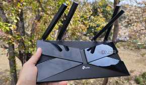 A person holding a TP-Link router