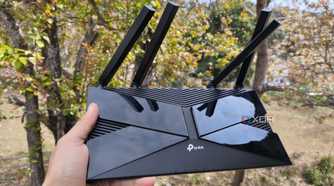 A person holding a TP-Link router
