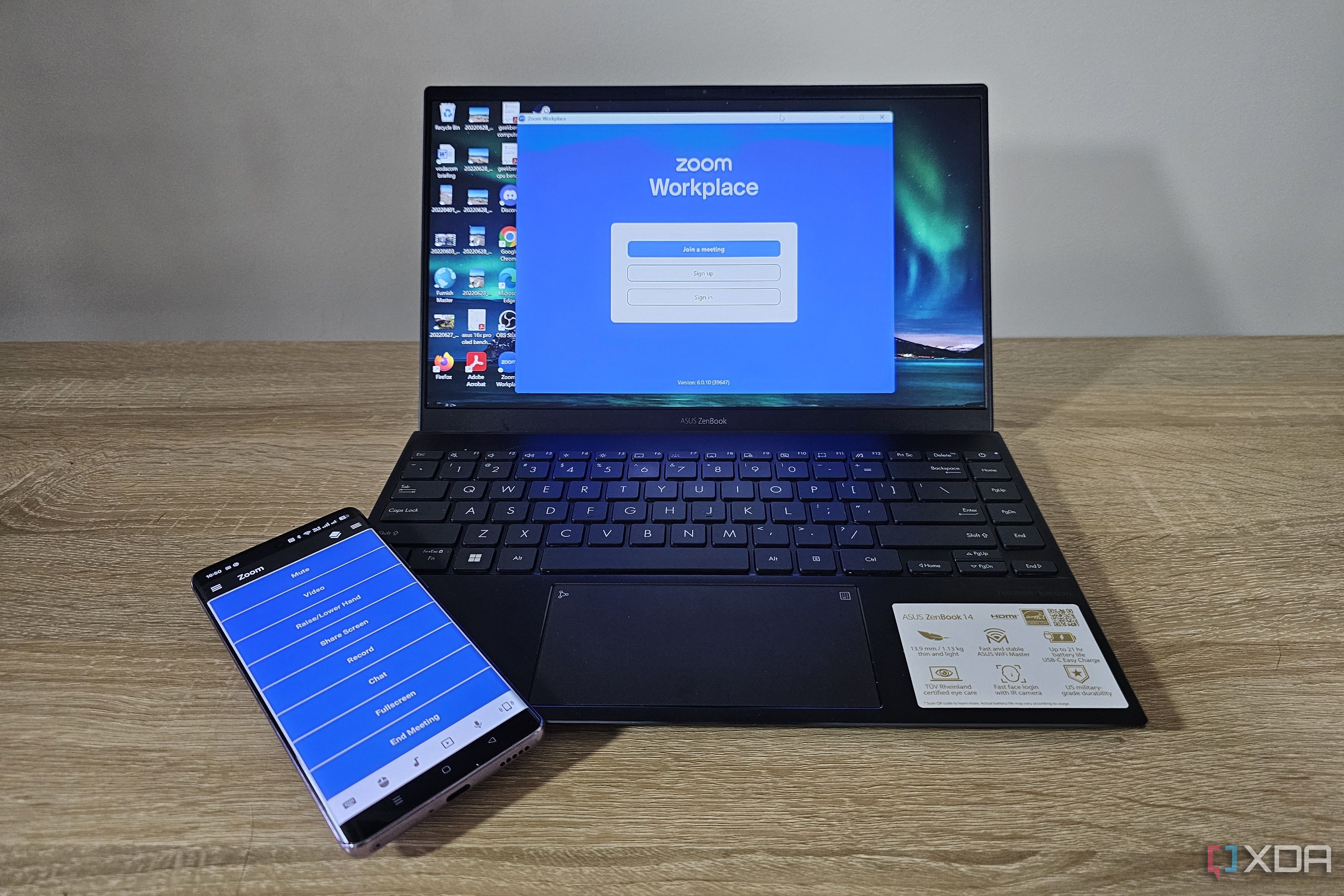 unified remote app on smartphone with laptop showing zoom