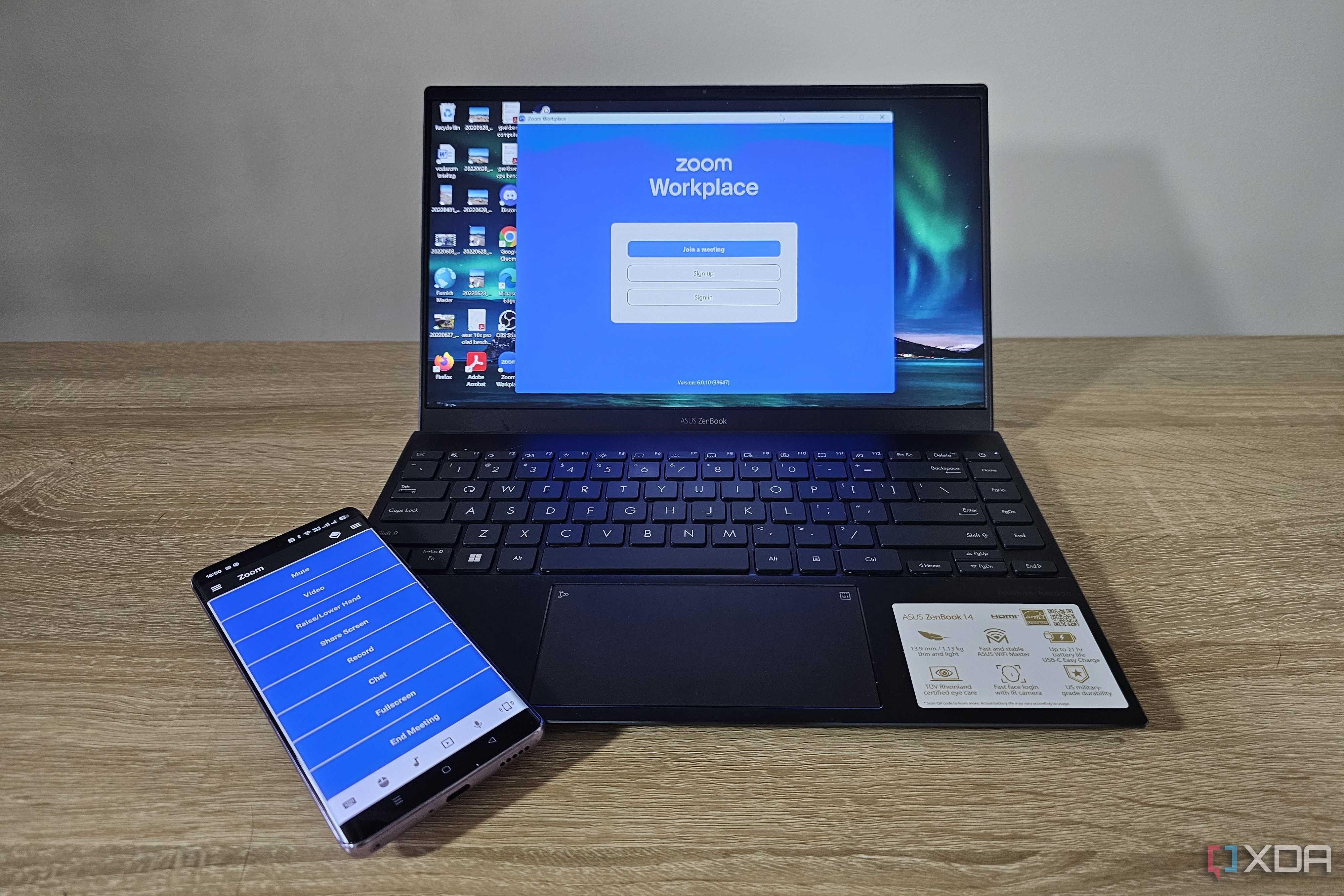 unified remote app on smartphone with laptop showing zoom