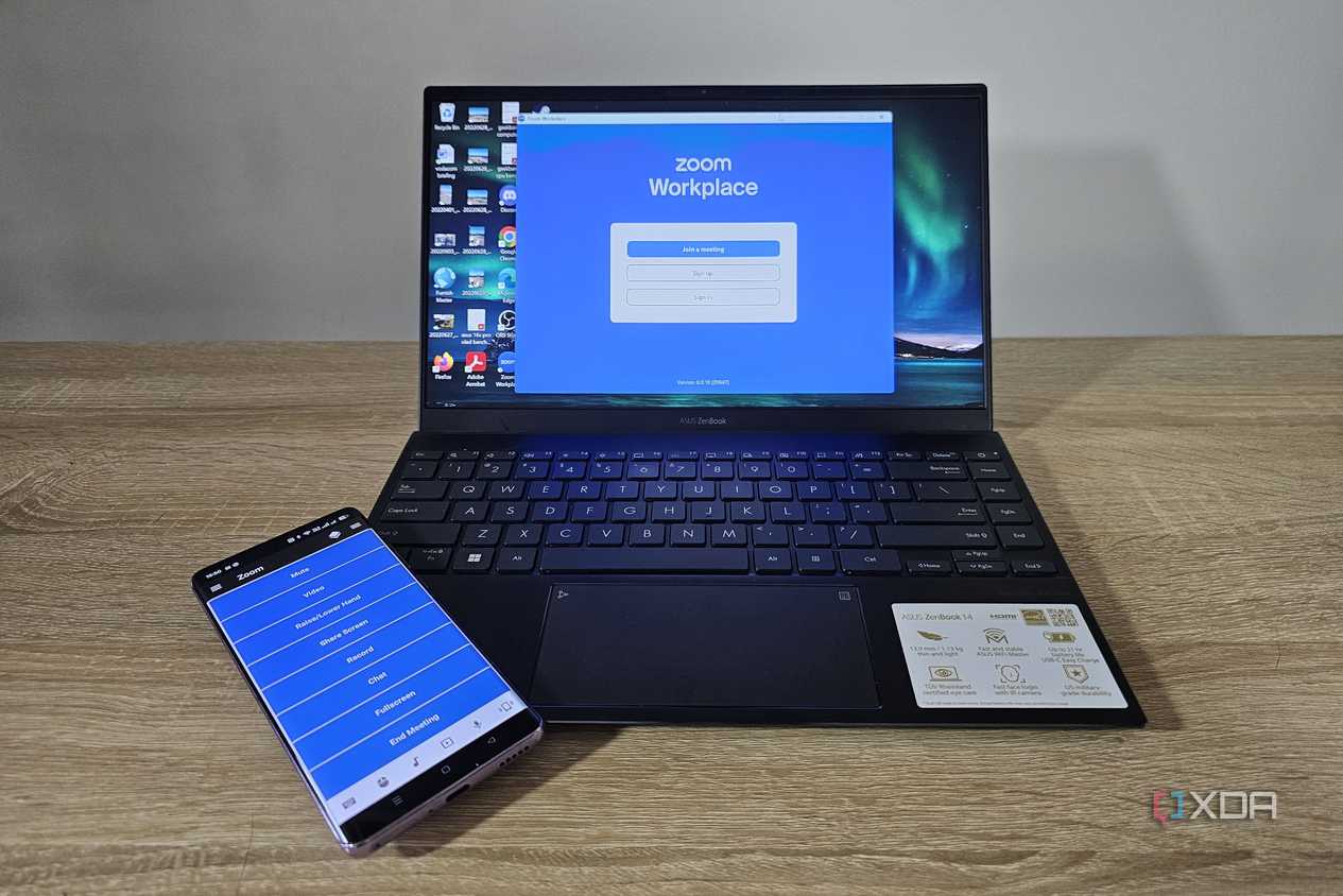 unified remote app on smartphone with laptop showing zoom