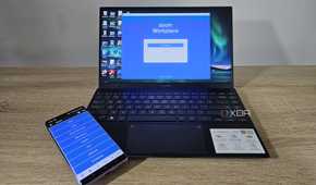 unified remote app on smartphone with laptop showing zoom