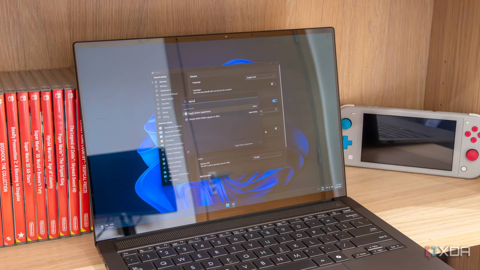 A Windows 11 laptop showing the Ueli settings window and search bar
