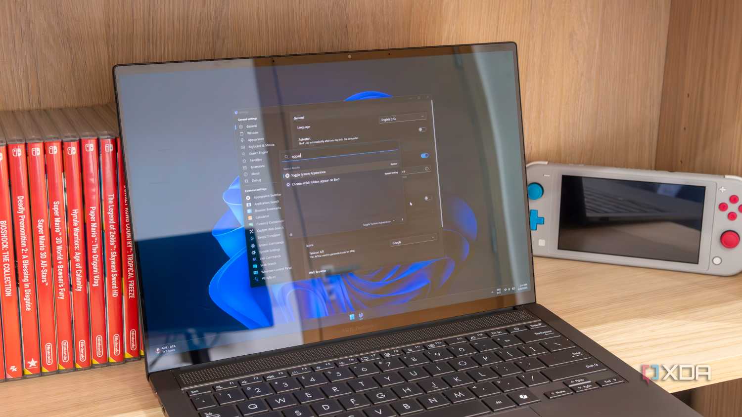 A Windows 11 laptop showing the Ueli settings window and search bar