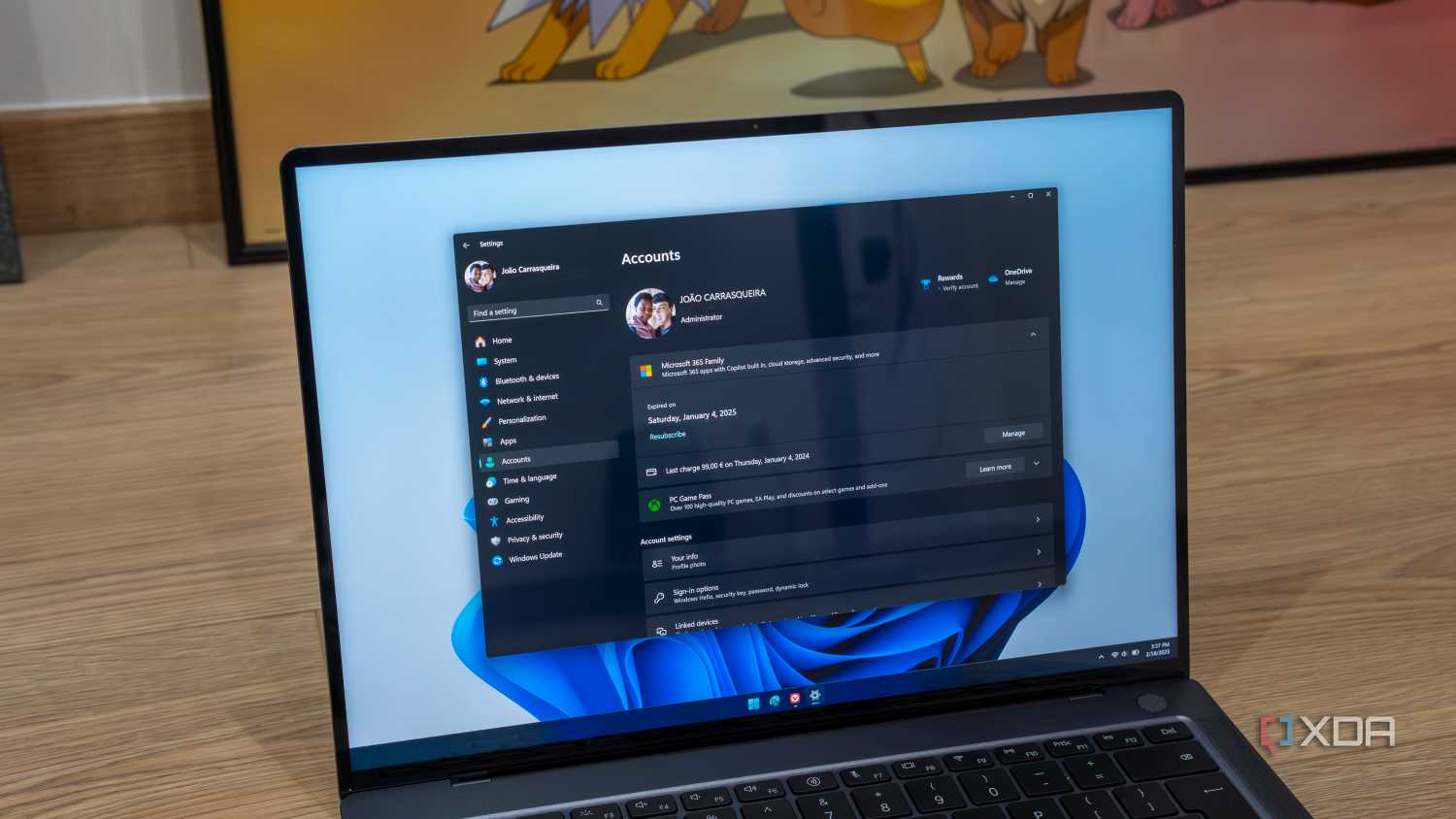 A Windows 11 laptop showing Microsoft account information in the Settings app