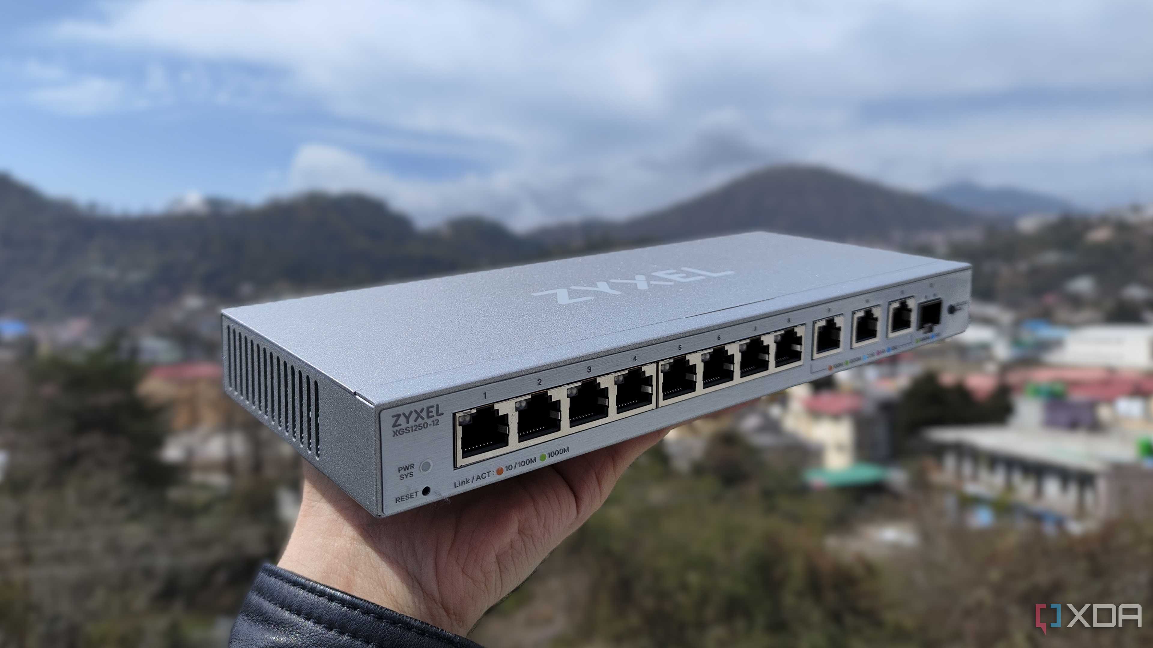 A person holding a Zyxel network switch