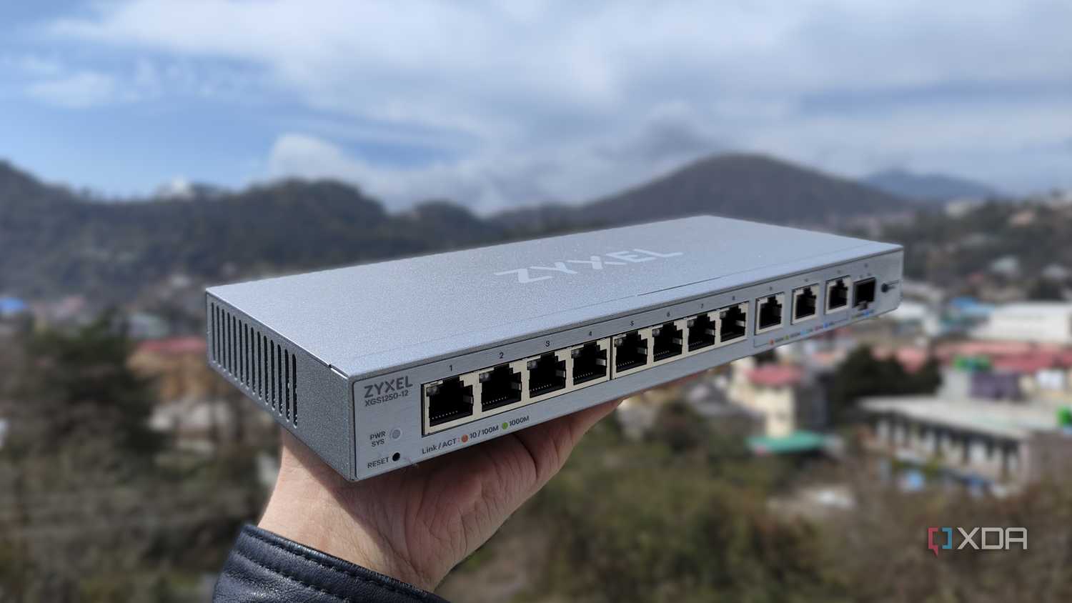 A person holding a Zyxel network switch