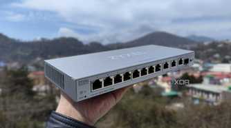 A person holding a Zyxel network switch