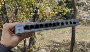 A person holding a Zyxel network switch