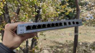 A person holding a Zyxel network switch