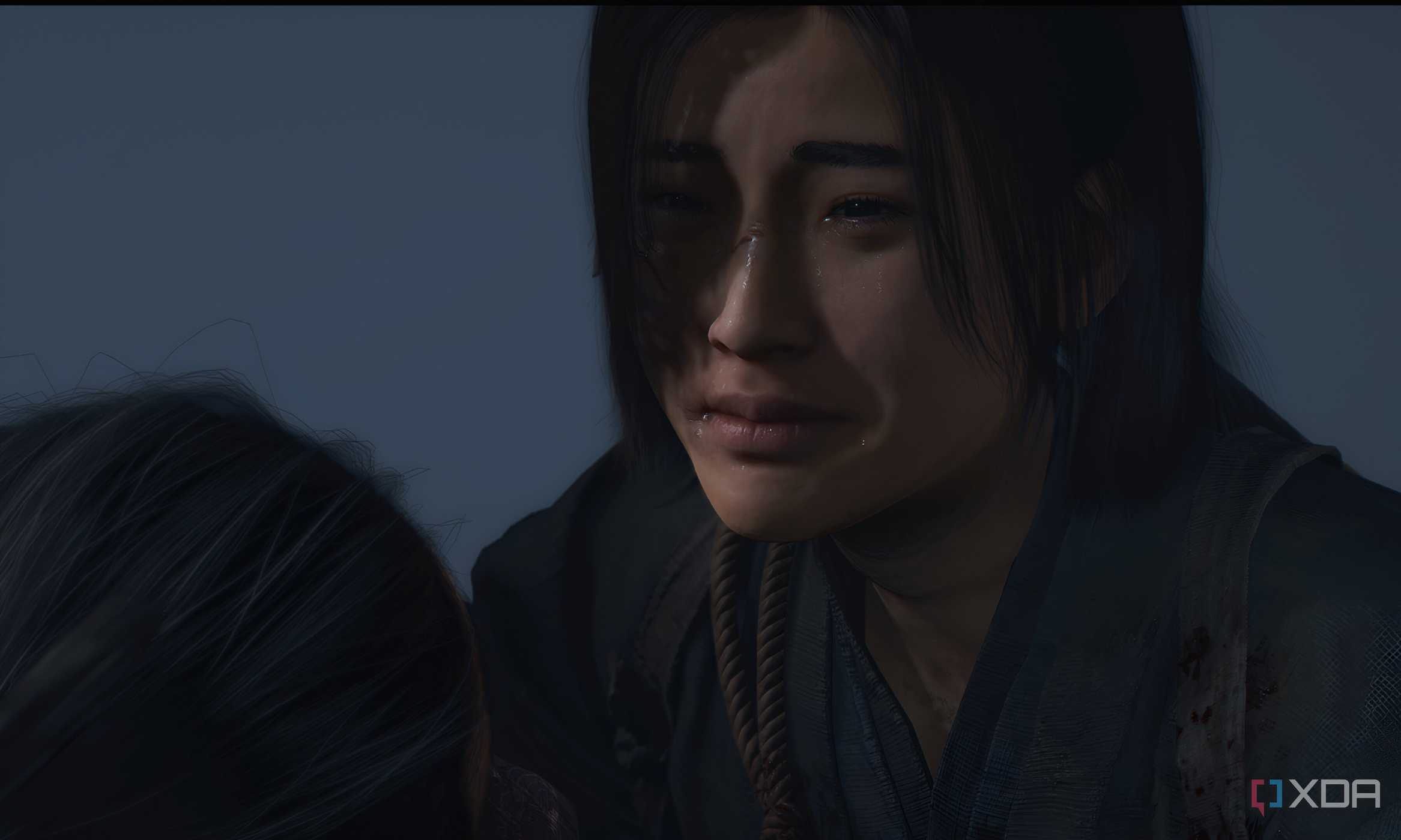A screenshot from Assassin's Creed Shadows, showing the female protagonist crying.