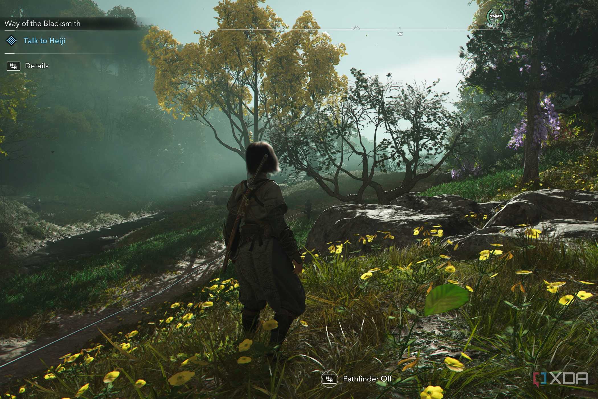 A screenshot from Assassin's Creed Shadows, showing Naoe, the protagonist, standing while surrounded by foliage.