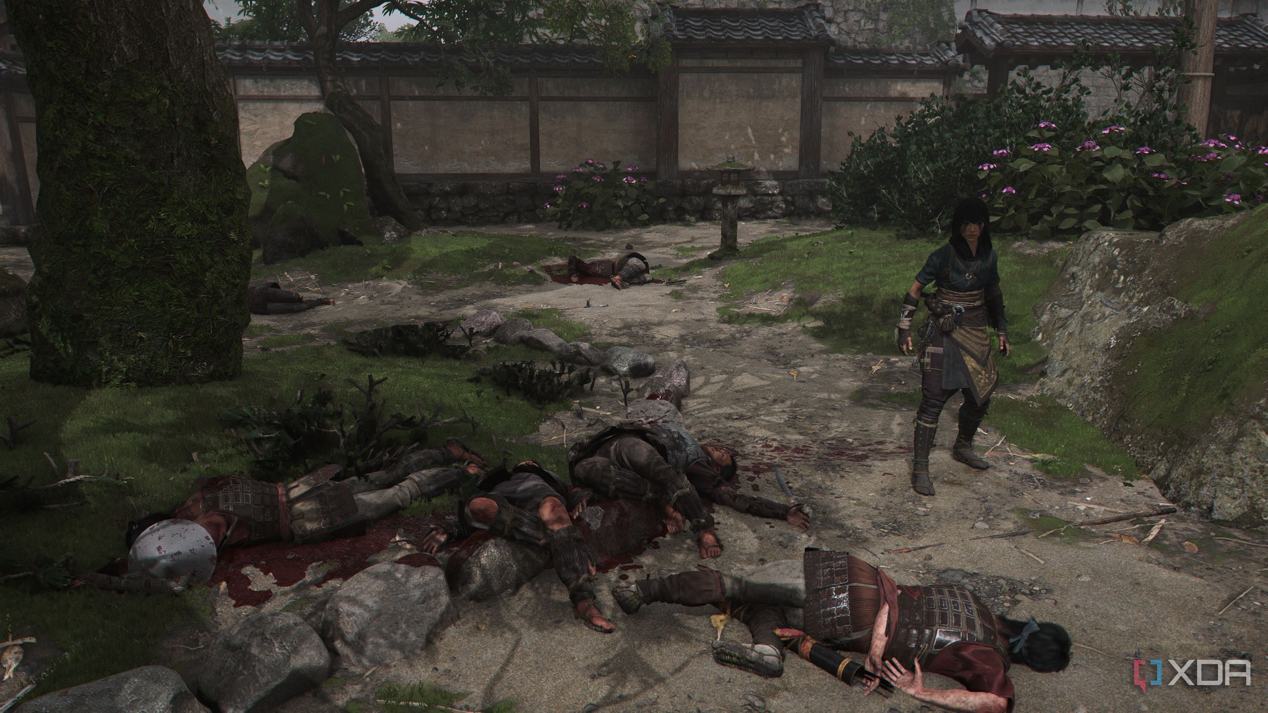 A screenshot from Assassin's Creed Shadows, showing Naoe, the female protagonist, standing next to four corpses.