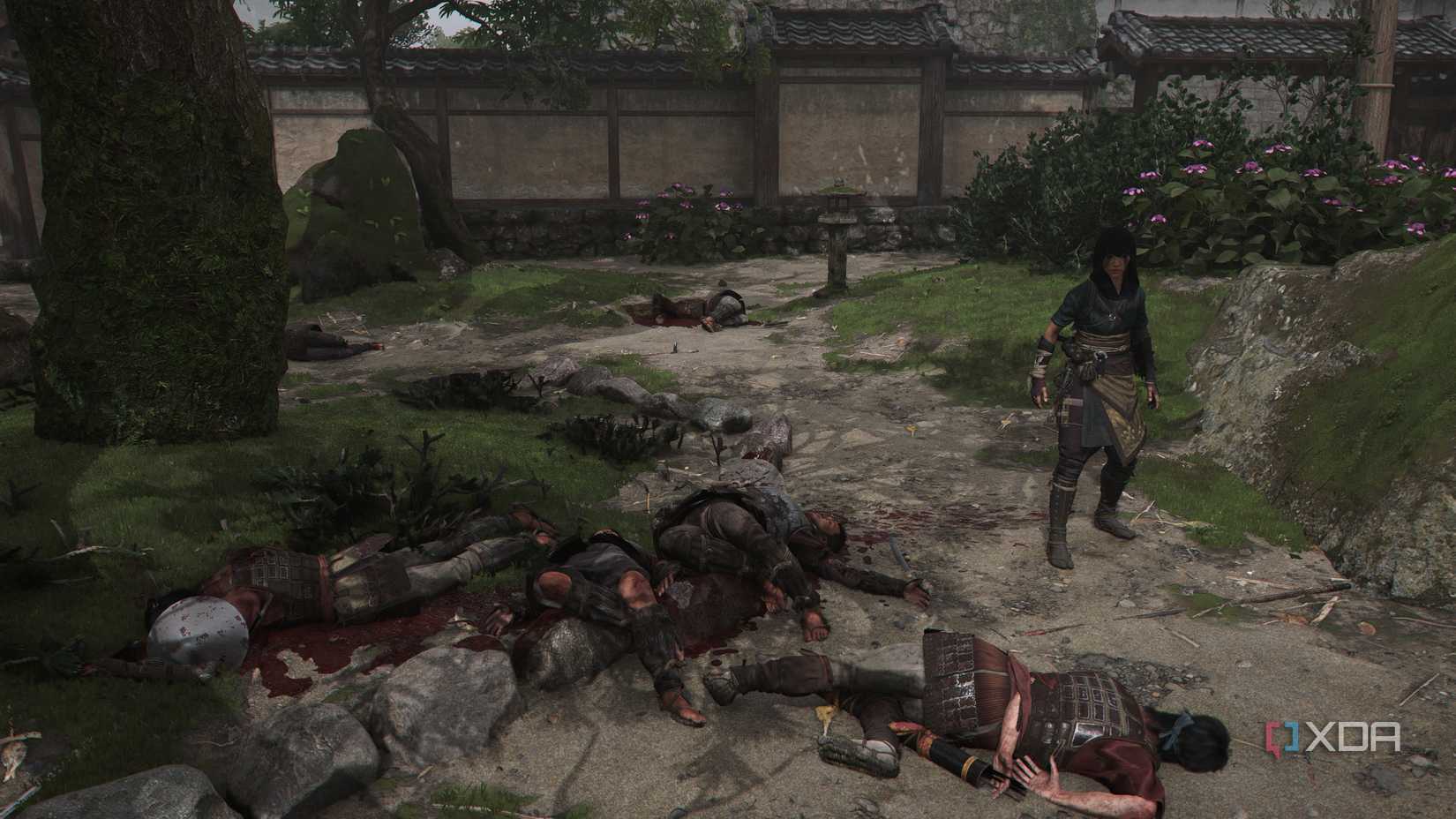 A screenshot from Assassin's Creed Shadows, showing Naoe, the female protagonist, standing next to four corpses.