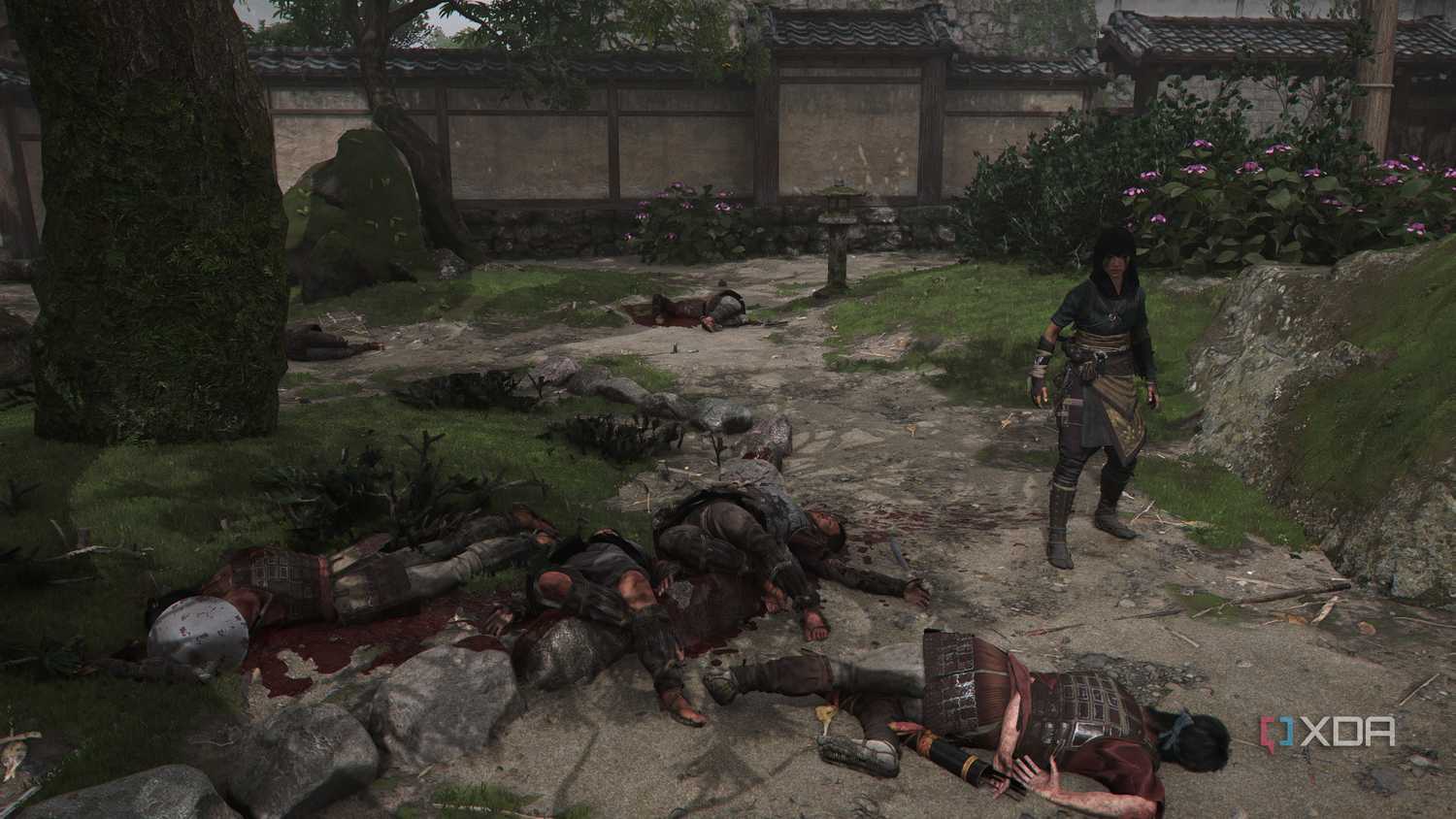 A screenshot from Assassin's Creed Shadows, showing Naoe, the female protagonist, standing next to four corpses.