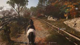 A screenshot from Assassin's Creed Shadows, showing Naoe riding on horseback down a windy mountain trail.
