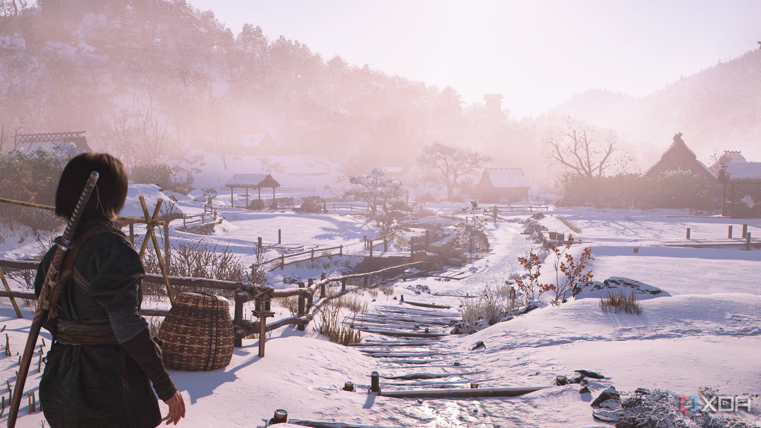 A screenshot from Assassin's Creed Shadows, showing a snow-covered village.
