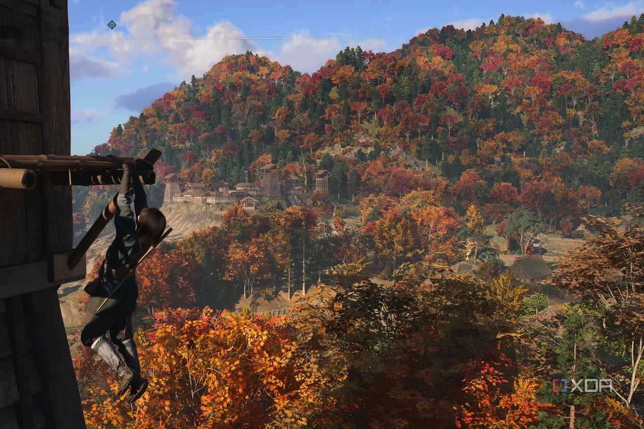 A screenshot from the game Assassin's Creed Shadows, showing Naoe, the protagonist, hanging from a wooden ledge.