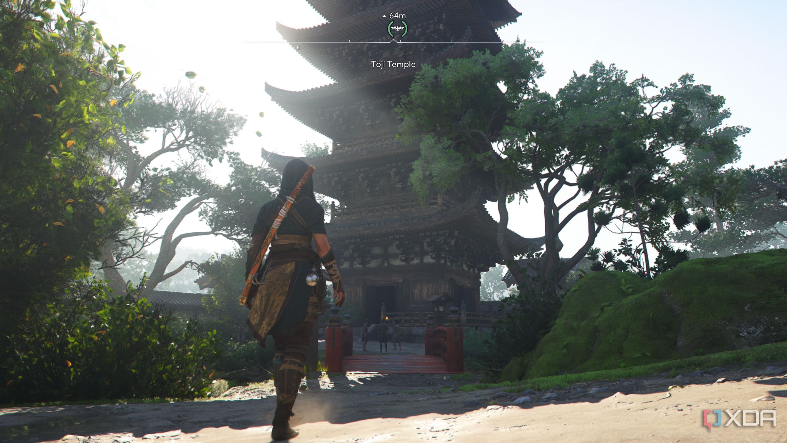 A screenshot from Assassin's Creed Shadows, showing Naoe, the female protagonist, walk up to a temple.