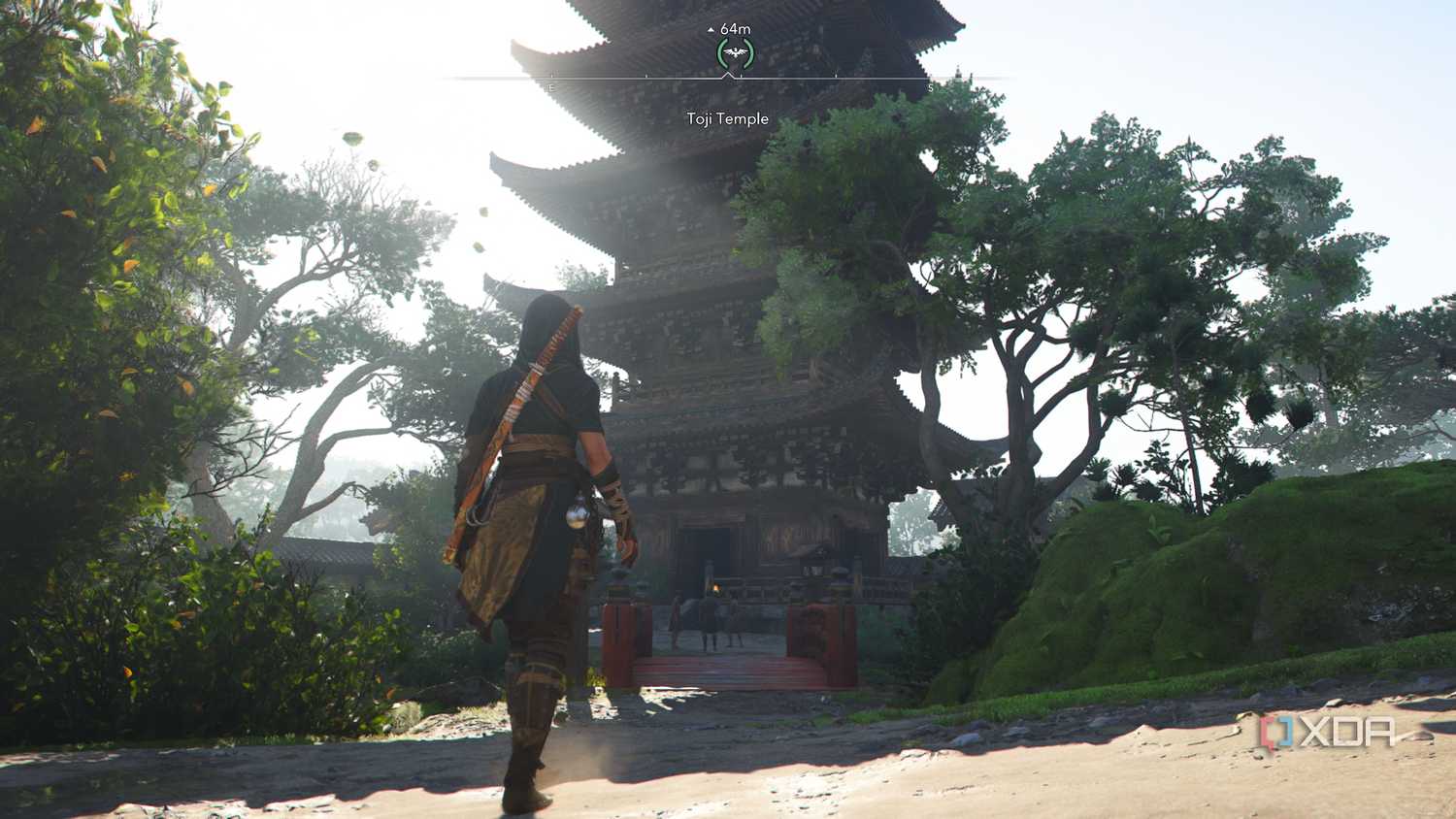 A screenshot from Assassin's Creed Shadows, showing Naoe, the female protagonist, walk up to a temple.