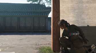 A screenshot from the game Assassin's Creed Shadows, showing Naoe, the protagonist, crouched behind a wall.