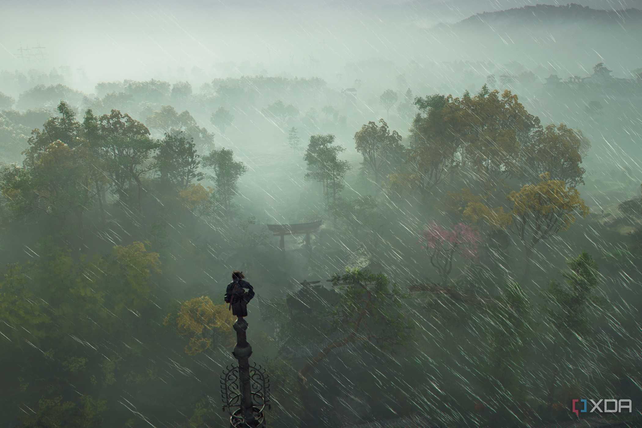 A screenshot from Assassin's Creed Shadows, showing Naoe, the protagonist, perched atop a tall pillar as rain sweeps around her.