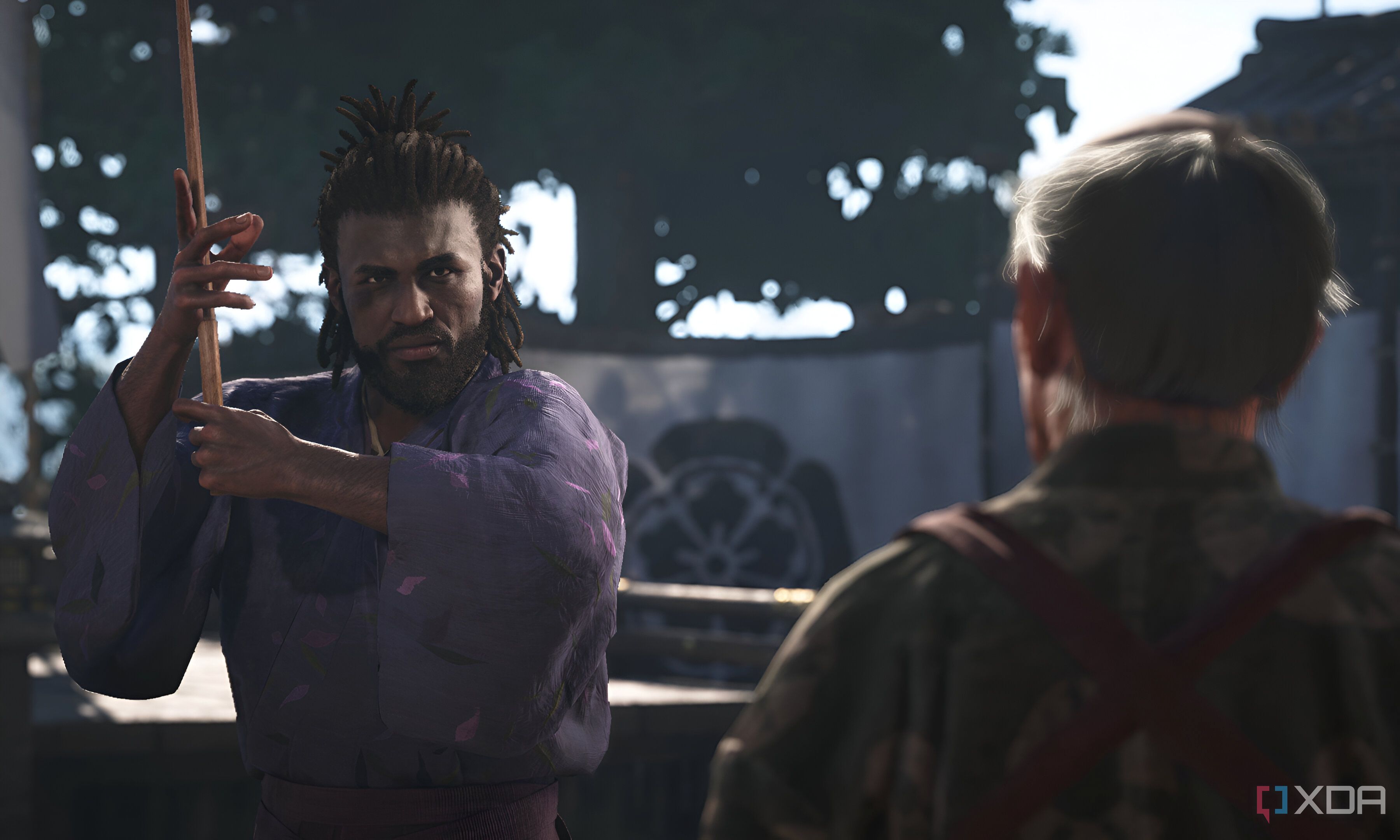 A screenshot from Assassin's Creed Shadows, showing Yasuke, the protagonist, holding a wooden sword or bokken.