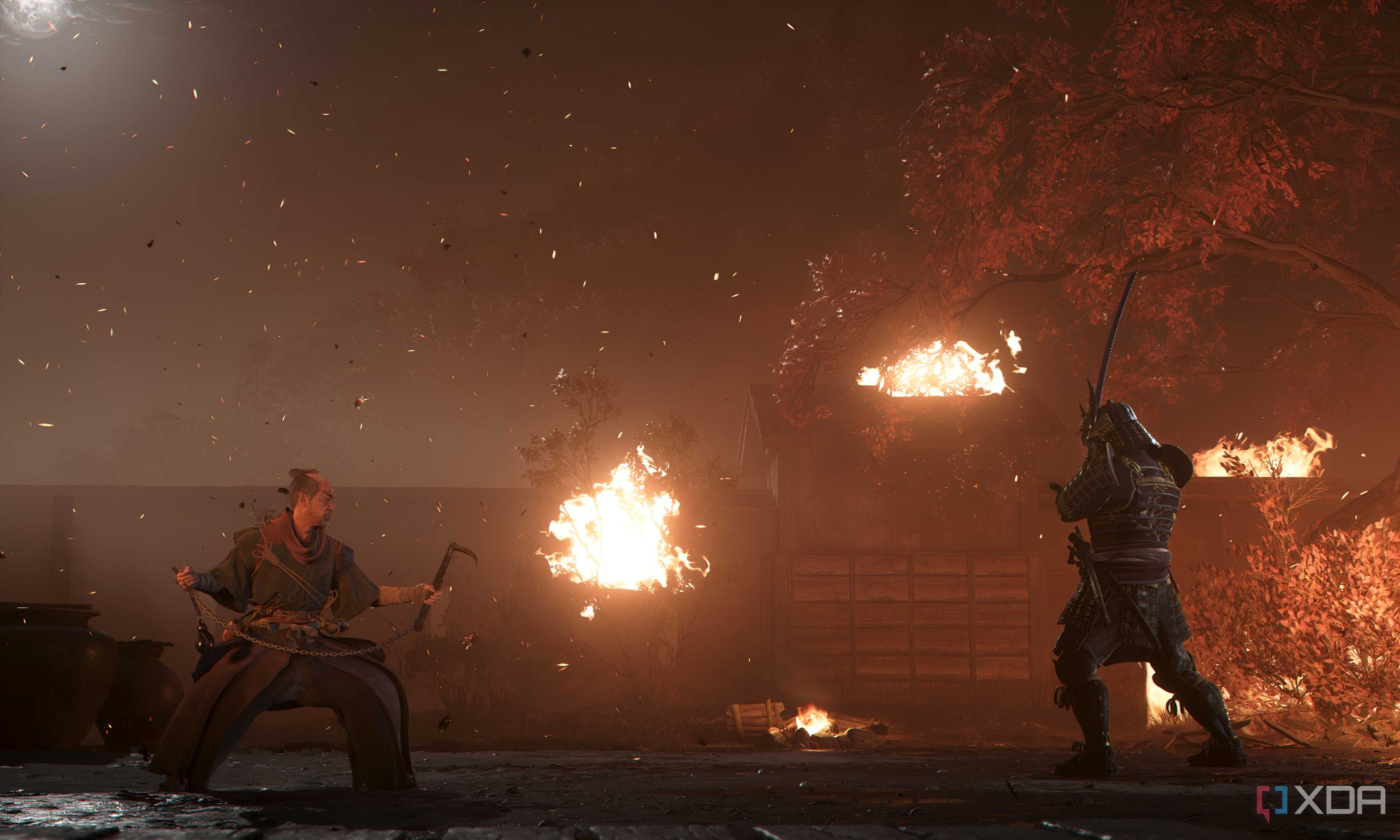A screenshot from Assassin's Creed Shadows, showing two men ready themselves for battle as fire rages around them.
