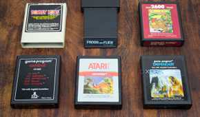 Atari and Coleco games on a wood table