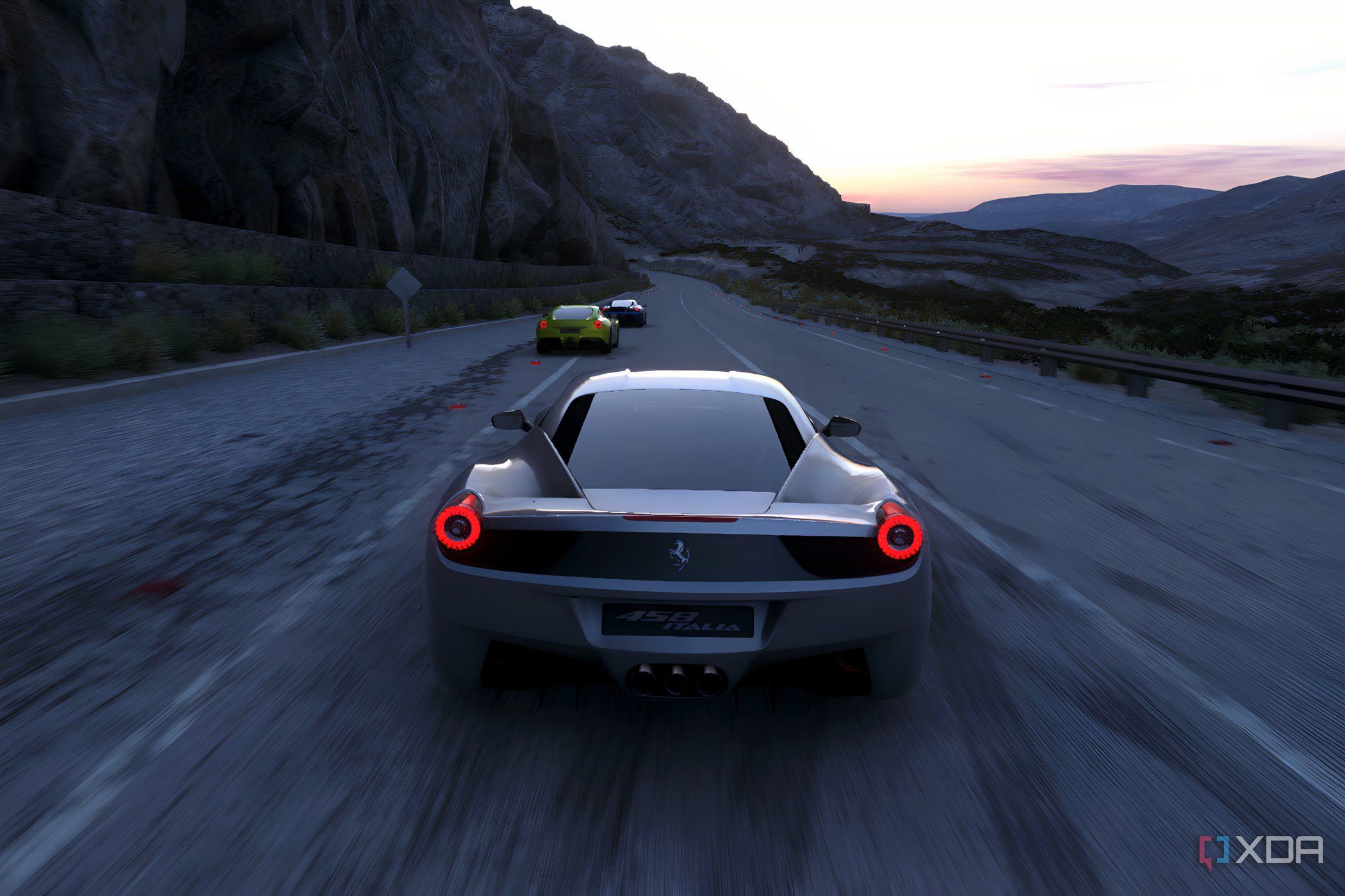 An image from the 2014 game Driveclub, showing a silver Ferrari racing on a mountain road.