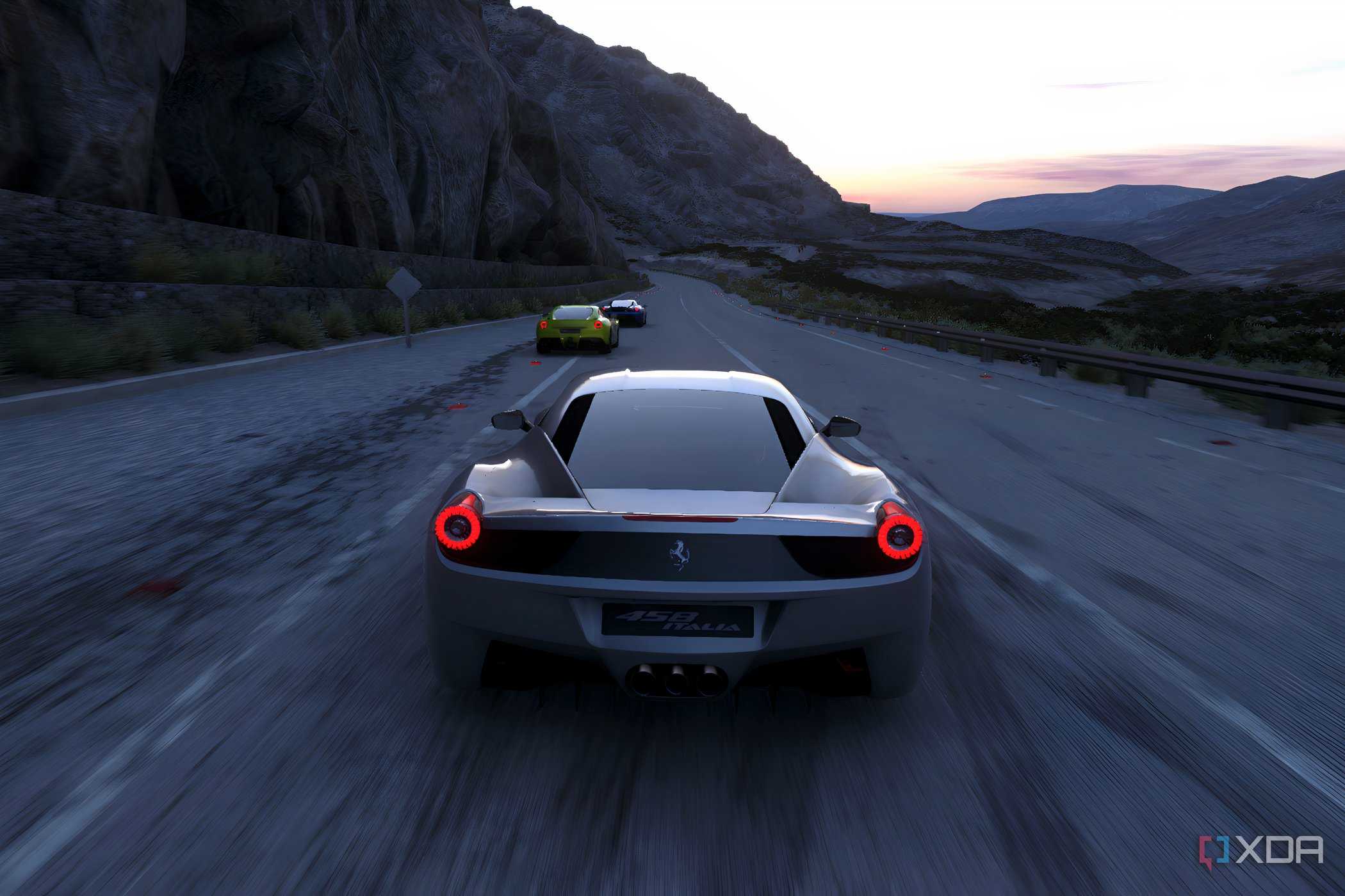 An image from the 2014 game Driveclub, showing a silver Ferrari racing on a mountain road.