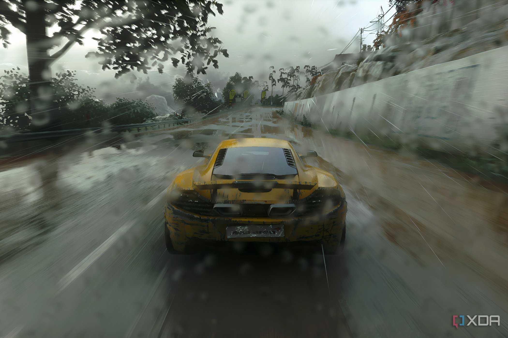 An image from the 2014 game Driveclub, showing the rear of a yellow McLaren as it races while the rain pours down heavily.
