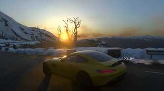 An image from the 2014 game Driveclub, showing a yellow Mercedes car frmo the side, driving in a snowy setting as the sun rises.