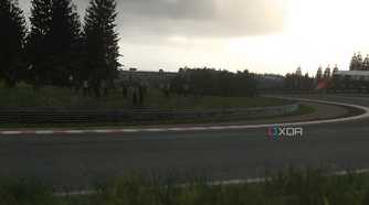 An image from the 2014 game Driveclub, showing a sunlit winding track with grass fields around it.