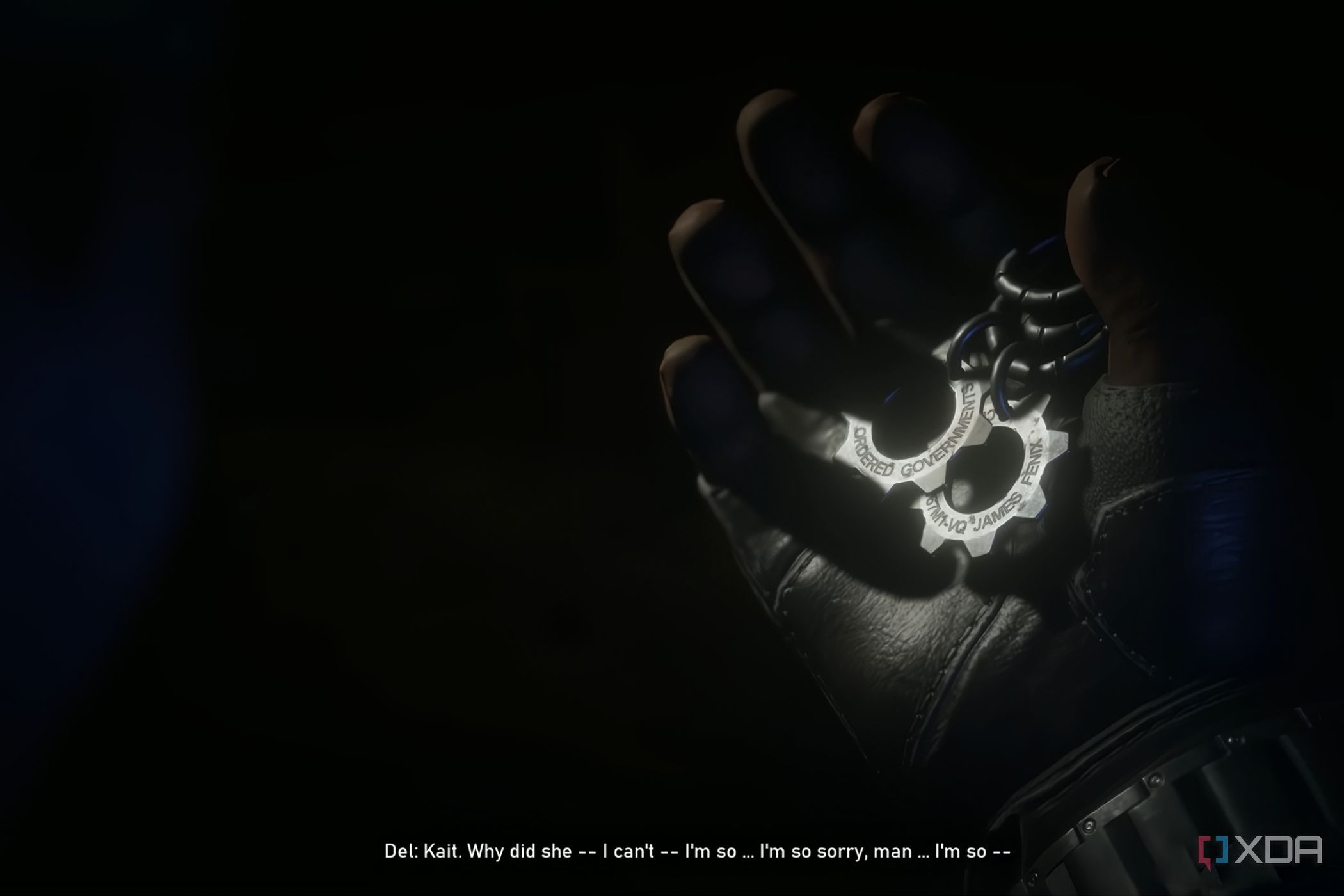 A screenshot from the game Gears 5, showing gear-shaped COG tags being held in a gloved hand.