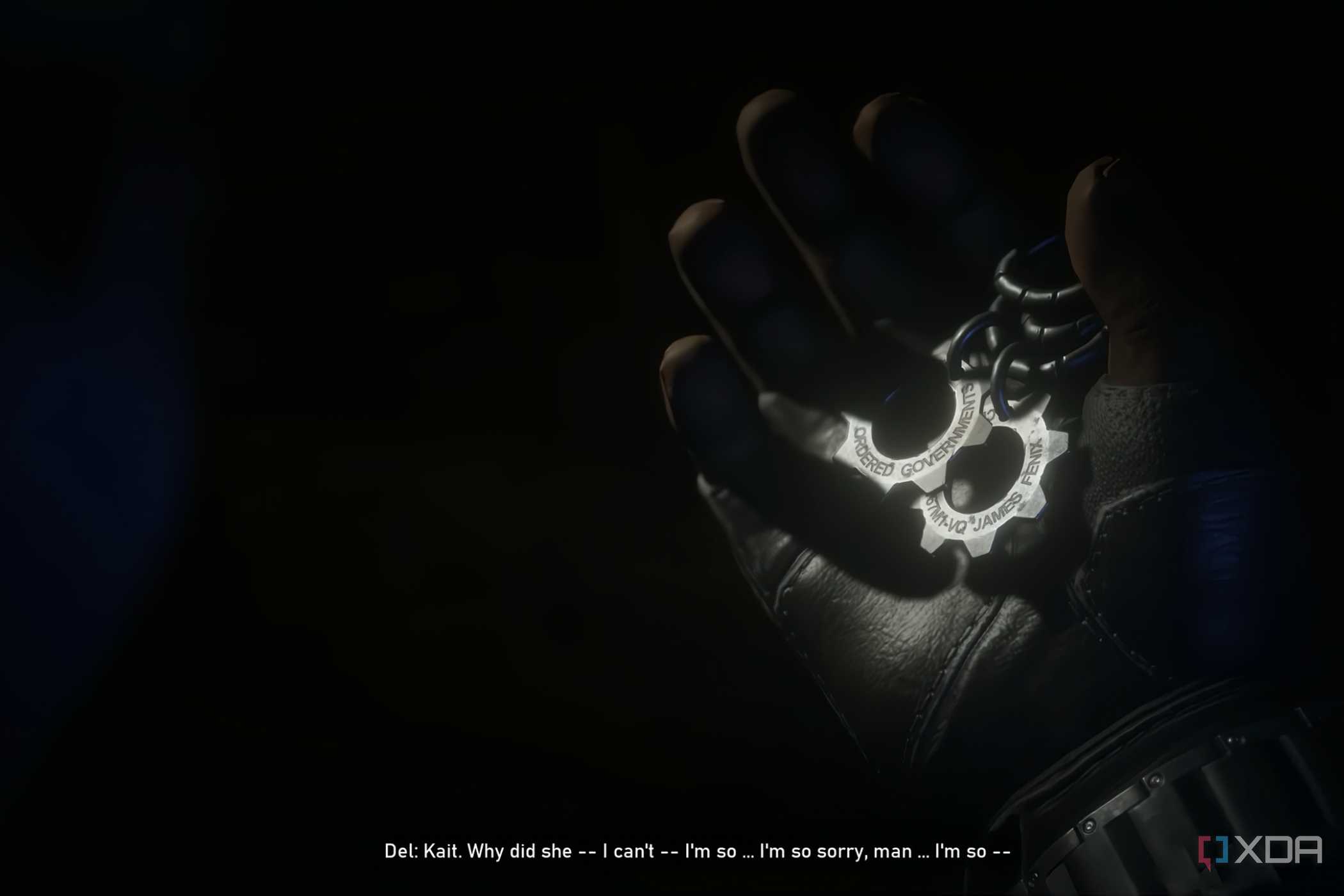 A screenshot from the game Gears 5, showing gear-shaped COG tags being held in a gloved hand.