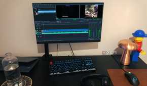 Kdenlive displayed on PC desktop, with lamp, bottle, lego, and chromebook in view