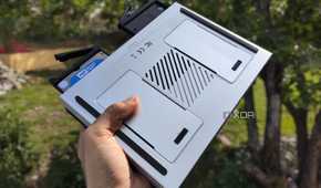 A person holding the LincPlus LincStation N2 NAS, with two drives popping out of the NAS