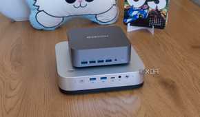 A Minisforum AI X1 Pro laid horizontally with a Geekom GT1 Mega on top of it