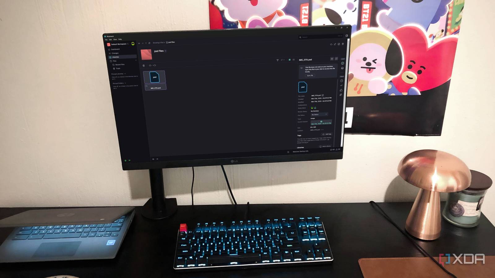 Mudstack cloud storage tool displayed on desktop PC, with lamp, chromebook, and poster in view
