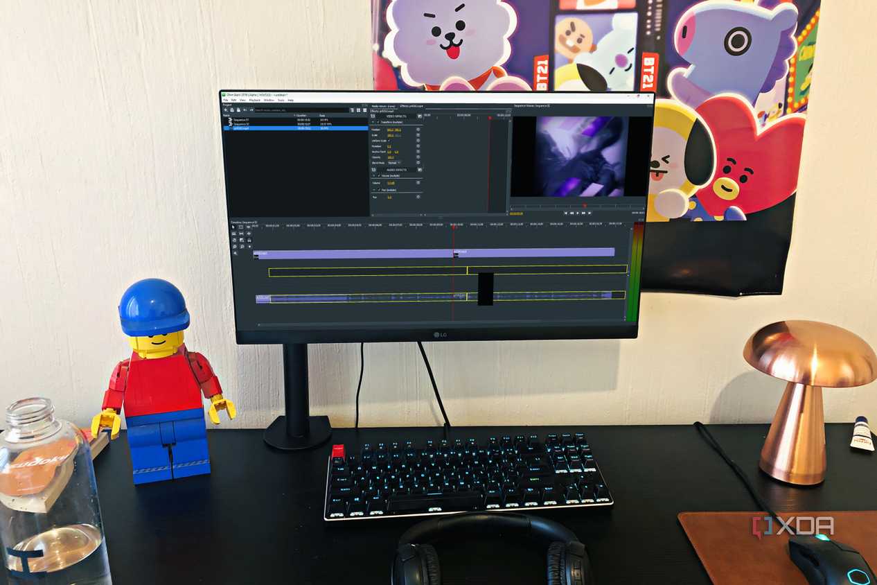 Olive video editor displayed on desktop PC, with lego, poster, and lamp in view