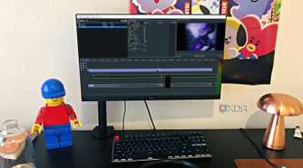 Olive video editor displayed on desktop PC, with lego, poster, and lamp in view