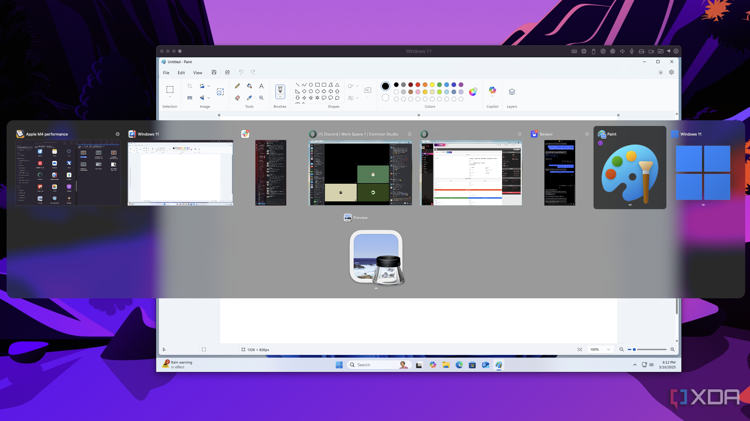Screenshot of a Windows 11 VM running inside macOS with the macOS task switcher showing the Windows 11 Paint app as one of the apps the user can switch to