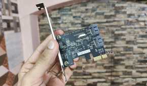 A person holding a PCIe-to-USB card