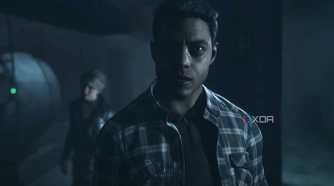 A screenshot from the game "Until Dawn", showing a man in a flannel shirt.