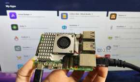 A person holding a Raspberry Pi in front of a screen displaying a RunTiPi server