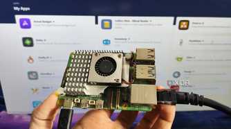 A person holding a Raspberry Pi in front of a screen displaying a RunTiPi server