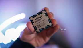 A hand holding the Ryzen 9 9950X3D.