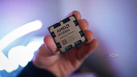 A hand holding the Ryzen 9 9950X3D.